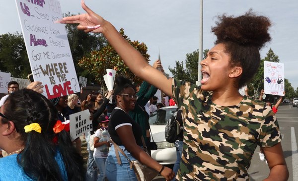 Anaya Keller Jones leads a chant during Monday's protest march through Lemoore. 